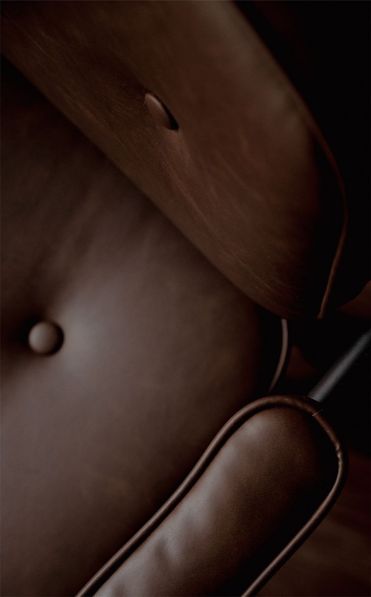 Detail of a bespoke leather and timber lounge chair
