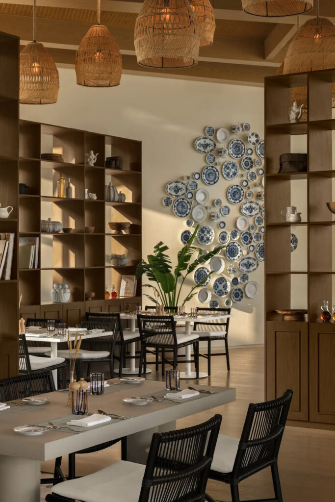 Bespoke teak restaurant joinery and decorative plate wall art at SLS Hotels Shura Island luxury hospitality project.