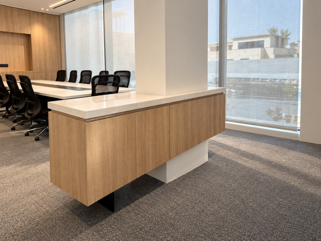 Bespoke timber cabinetry with a stone top inside the modern One Software office meeting room overlooking exterior views